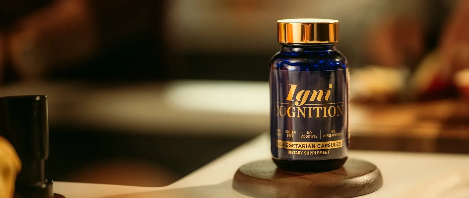 A bottle of IgniCognition on a wooden coaster on a kitchen counter